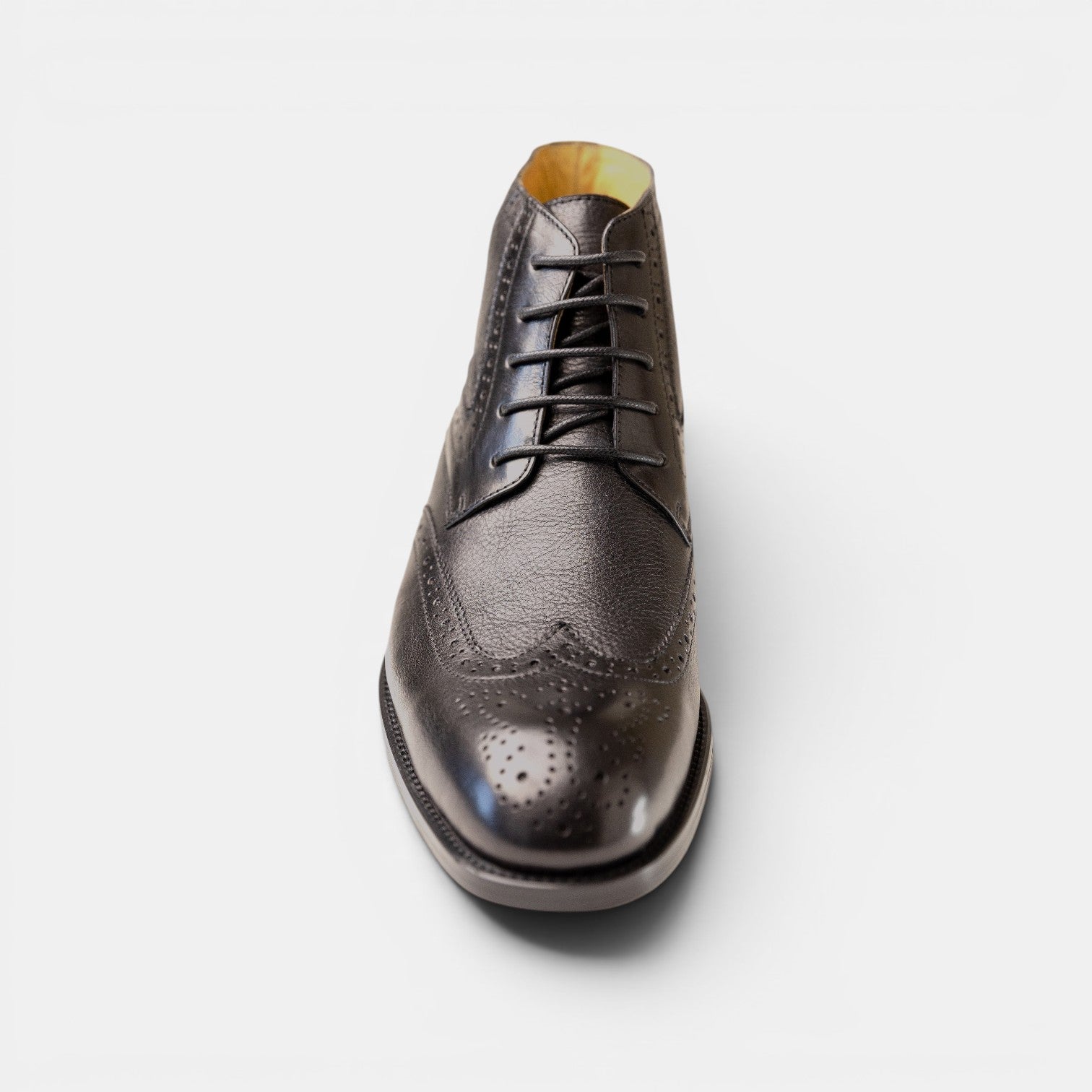 Barcon Getta Inc MAPUTO black textured leather wingtip lace-up boots with brogue detailing.