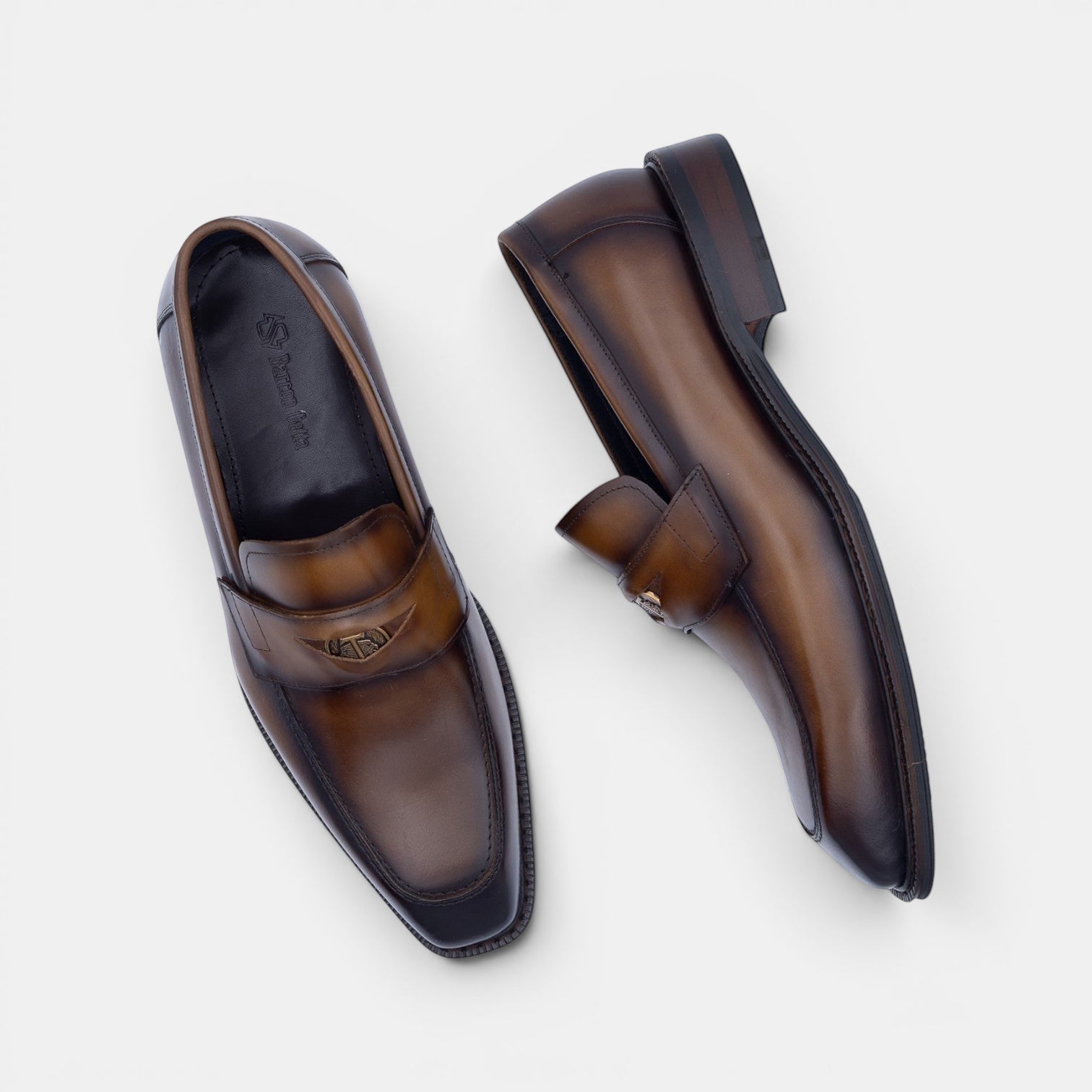 Barcon Getta Inc NEGUS brown leather penny loafers with metal accent detail and square toe.