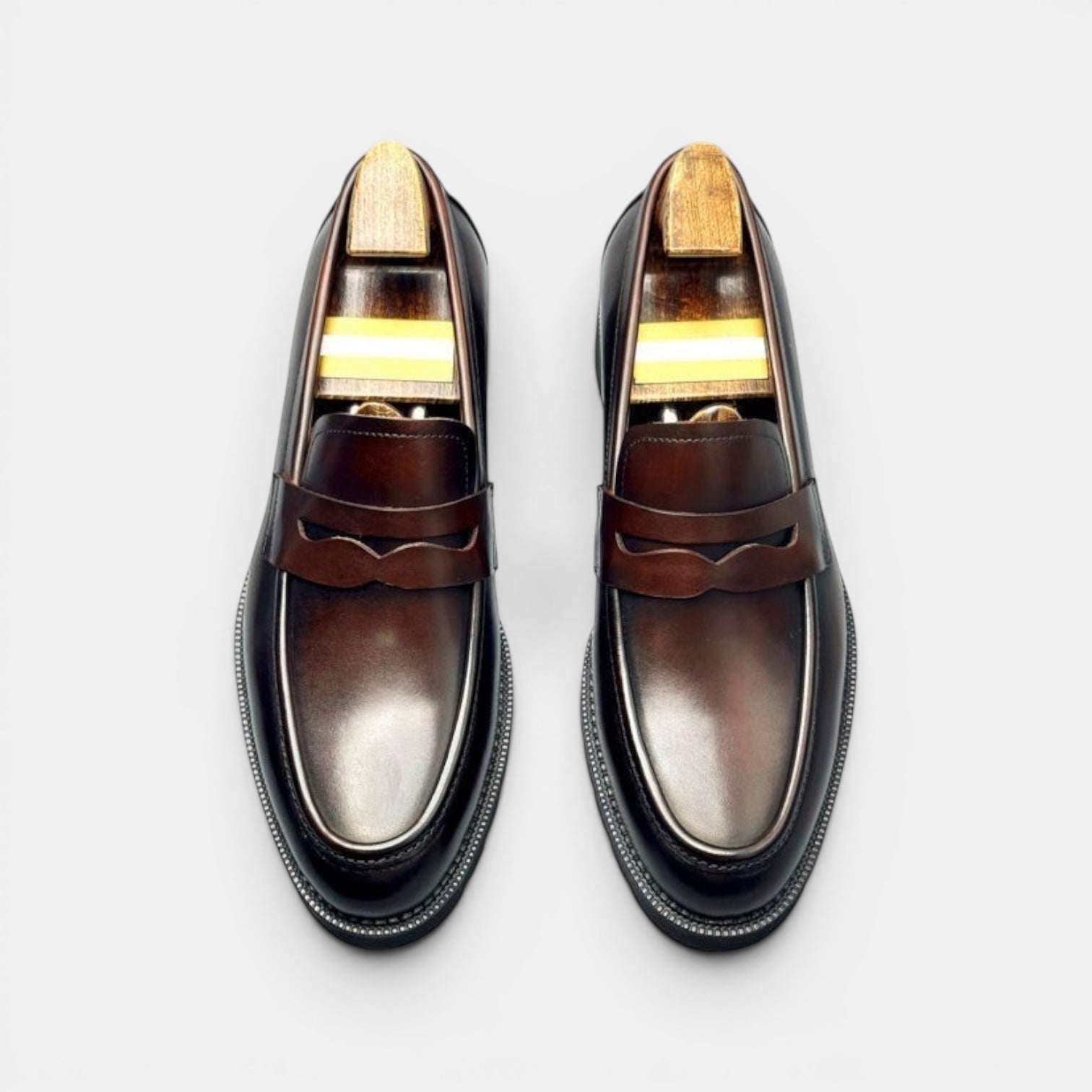 Barcon Getta Inc NIAMEY Penny Loafer in polished dark brown leather with a classic strap and lug sole.