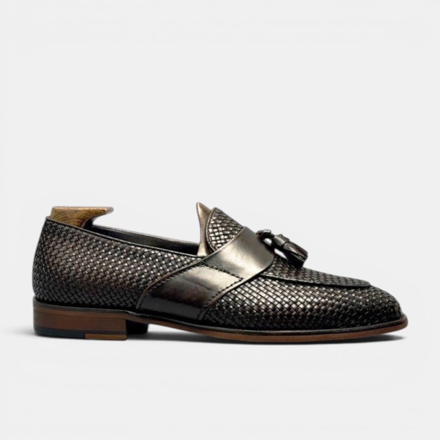 Barcon Getta Inc LIBREVILLE black woven leather tassel loafers with a smooth leather strap and classic tassel detail.