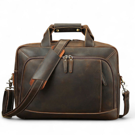 Brown leather briefcase with shoulder strap on a white background